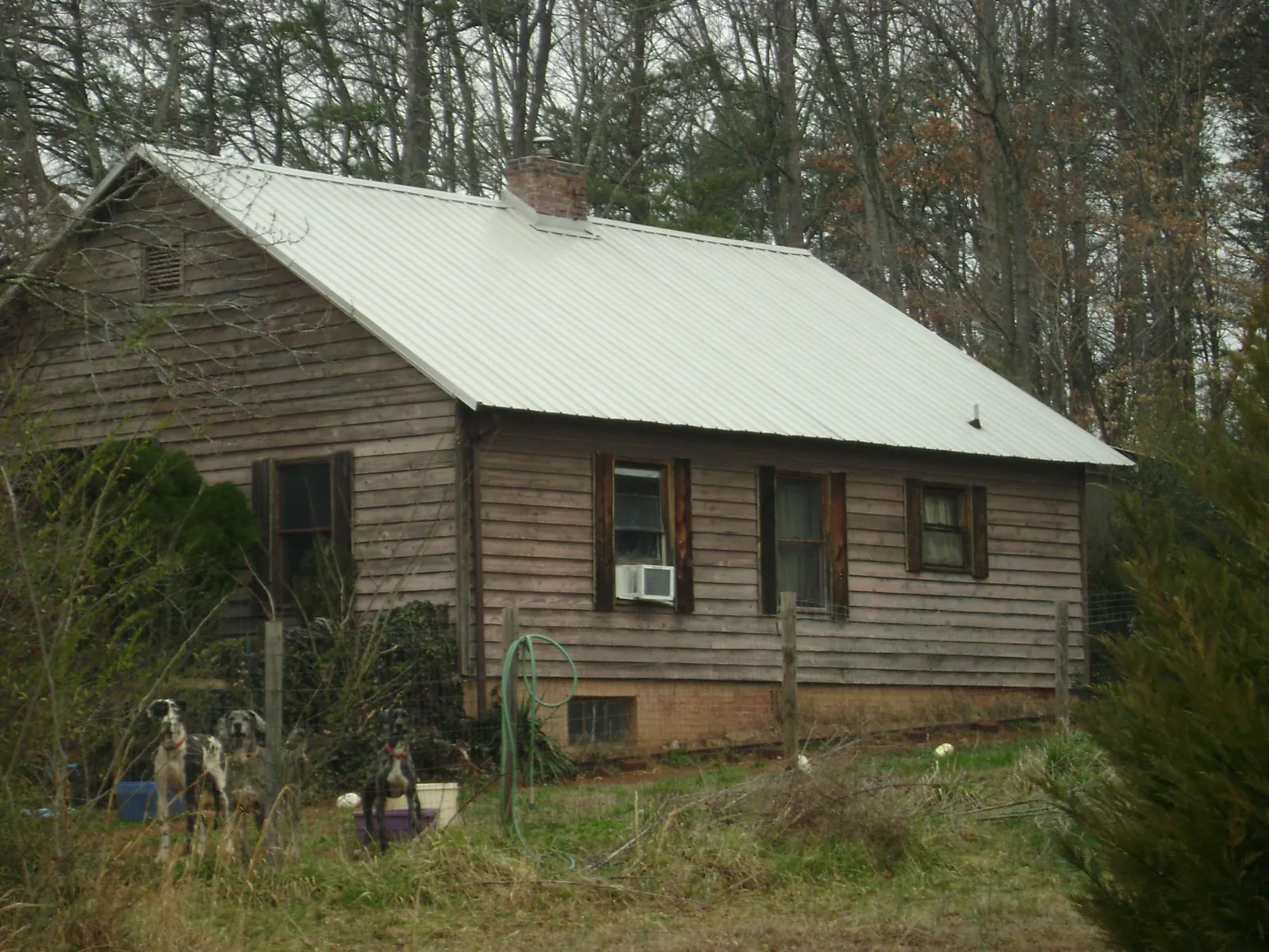White metal roof on an old wood sided farmhouse, from a Metal Roof Installation job in Rome City